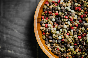 Peppercorn on rustic background.