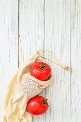 Reusable eco bags for shopping with tomato, replacing plastic bags
