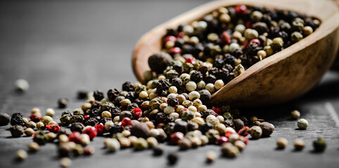 Peppercorn on rustic background.