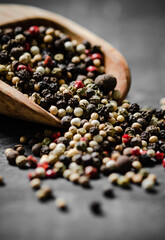 Peppercorn on rustic background.