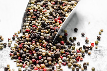 Peppercorn on rustic background.