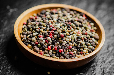 Peppercorn on rustic background.