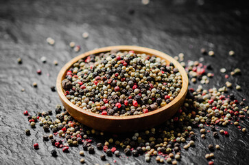 Peppercorn on rustic background.