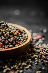 Peppercorn on rustic background.