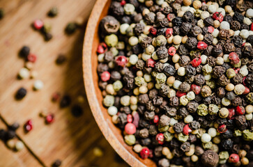 Peppercorn on rustic background.
