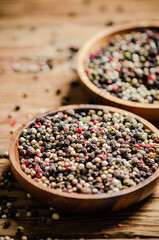 Peppercorn on rustic background. - 661002047