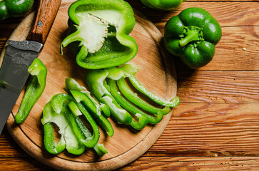 Chopped sweet pepper. On wooden table.