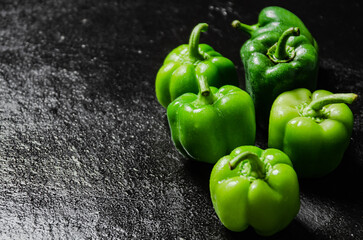 Fresh sweet pepper. On black table.