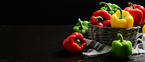 Fresh sweet pepper. On black table.