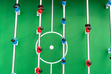 Top view of the football field and plastic players at a football match