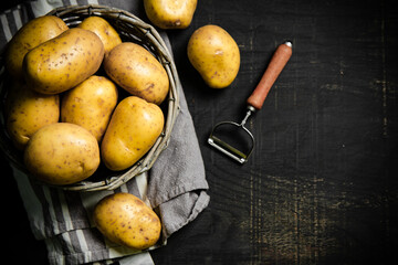 Fresh potatoes. On black background.