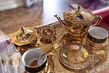 Golden tea set in the Royal Jewelry museum of Alexandria Egypt - obrazy, fototapety, plakaty