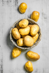 Fresh potatoes. On white table.