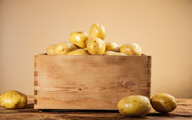Fresh potatoes. On wooden table.