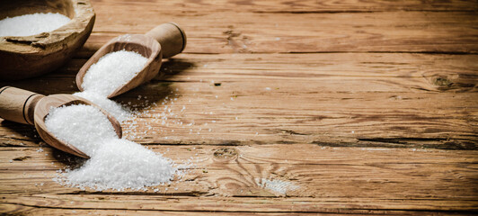 Salt background . On wooden table.