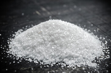 Salt background . On black table.