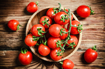 Fresh tomatoes. On wooden table.