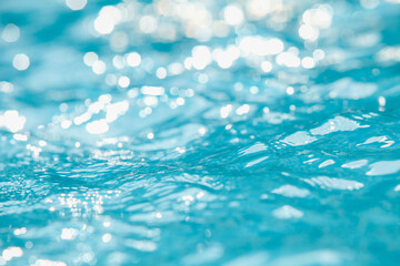 Water and air bubbles over blue background,sea wave ,Bokeh light background in the pool,Hotel swimming pool with sunny reflections. - obrazy, fototapety, plakaty