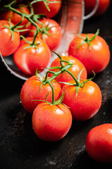 Fresh tomatoes. On black table.
