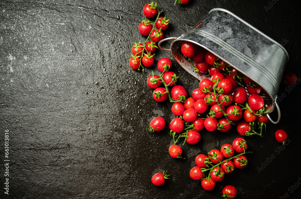 Poster Fresh tomatoes. On black table.