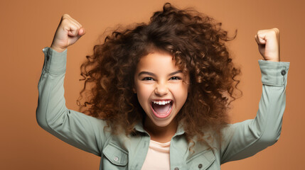 Curly-haired teenager with raised arms, singing and shouting in excitement.