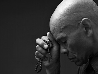 black man praying to god on gray background with people stock image stock photo