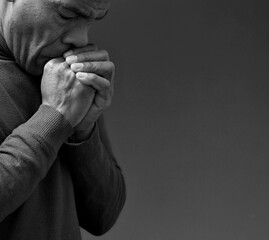 black man praying to god on gray background with people stock image stock photo