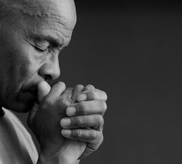 black man praying to god on gray background with people stock image stock photo