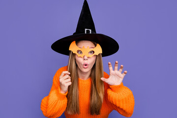 Photo of young young girl fooling behind bat mask masquerade halloween party terrifying witch say boo isolated on purple color background