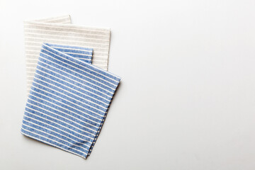 top view with blue kitchen napkin isolated on table background. Folded cloth for mockup with copy space, Flat lay. Minimal style