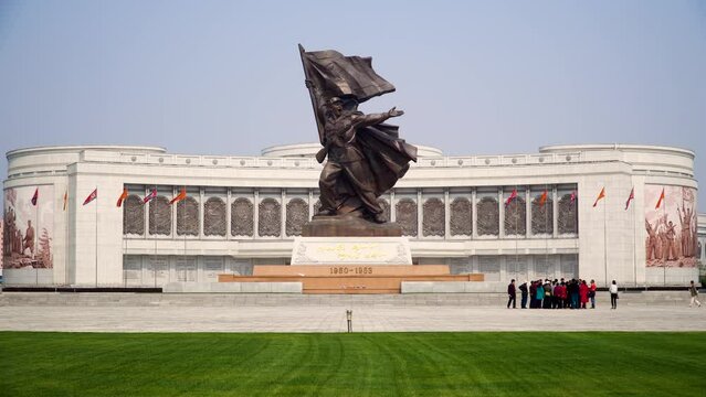 Pyongyang, North Korea, group of tourists visiting the Victory Monument Victory Monument