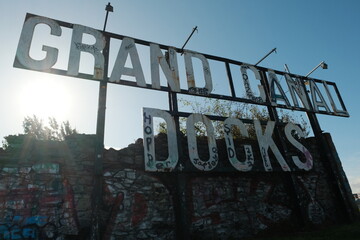 DUBLIN, IRELAND, OCTOBER 12 2023: Image of rusty old Grand Canal Dock sign beside river Liffey in...