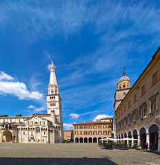 Modena, Italy. View of Cathedral with Ghirlandina tower located on Piazza Grande at dusk