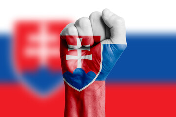 Man hand fist of SLOVAKIA flag painted. Close-up.