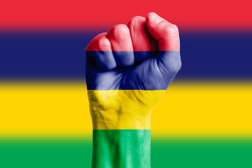 Man hand fist of MAURITIUS flag painted. Close-up.