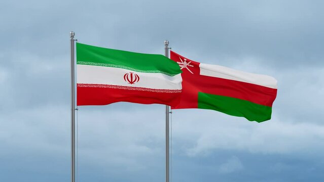 Oman and  Iran flag waving together on cloudy sky, endless seamless loop, two country cooperation concept
