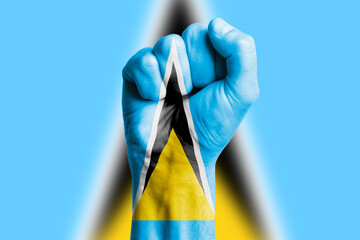 Man hand fist of SAINT LUCIA flag painted. Close-up.