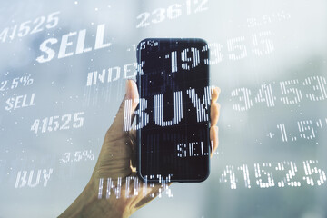 Abstract creative financial graph and hand with phone on background, forex and investment concept....