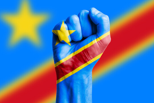 Man hand fist of CONGO DEMOCRATIC REPUBLIC flag painted. Close-up.
