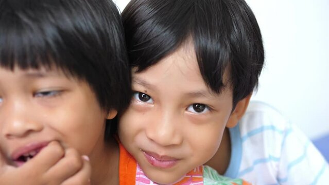 Asian boy being teased by his older brother and he sues his mother for help, teasing, bullying