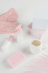 Skincare routine. Pink Women skincare products on white background. Soap, facial foam, cleansing, serum, cream lotion, lipstick. Beauty concept. Natural cosmetic pink flat lay top view