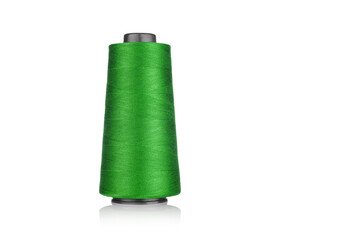 spool of industrial thread green color, texture of thread on a white background