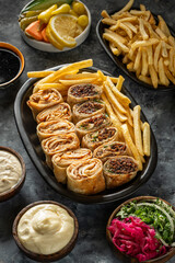 a plate of chicken and lamb shawarma with appetizers