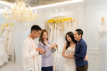 Obraz premium LGBT couples are choosing wedding gowns, with designers advising them on how to make them suitable and lovely for the bride.