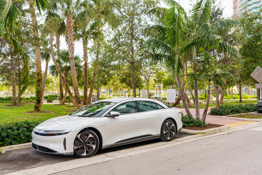 Photo of a Lucid Electric car sedan parked by a park