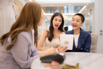 Fototapeta premium LGBT couples are choosing wedding gowns, with designers advising them on how to make them suitable and lovely for the bride.