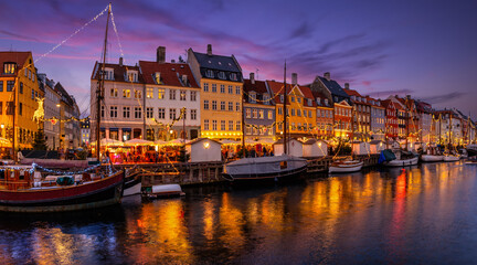 Beautiful winter evening view of the popular Nyhavn area at Copenhagen, Denmark, decorated for...