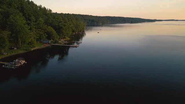 An aerial of docks along a lake edge at sunset