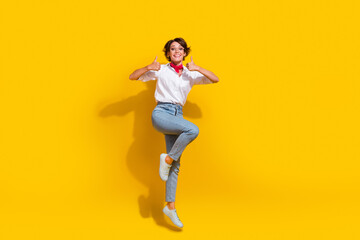 Fototapeta na wymiar Full length photo of satisfied overjoyed girl wear trendy fly air hand thumb up good job nice feedback isolated on yellow color background