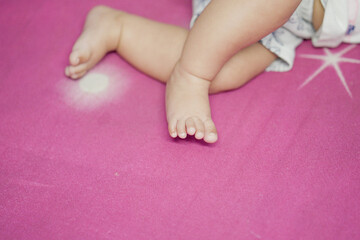 Obraz na płótnie Canvas Newborn Feet, three month feet baby girl, close-up of a baby's foot, Foot of indian baby girl, newborn baby feet while sleeping on bed at home stock images.